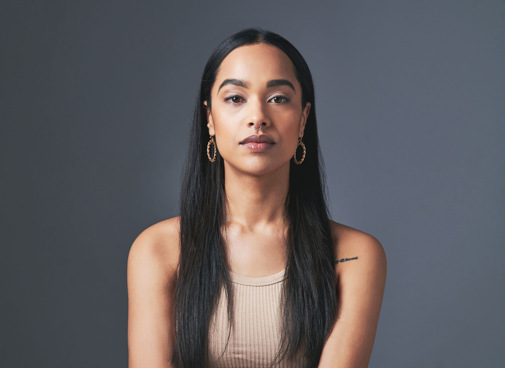 Woman with long hair and hoop earrings.
